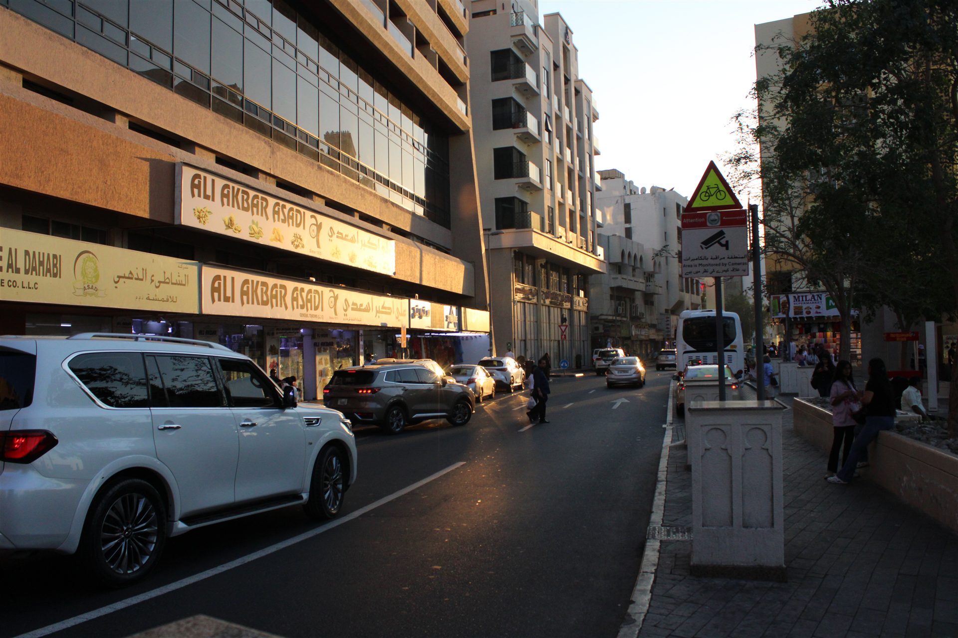 Late afternoon traffic and storefronts in Dubai