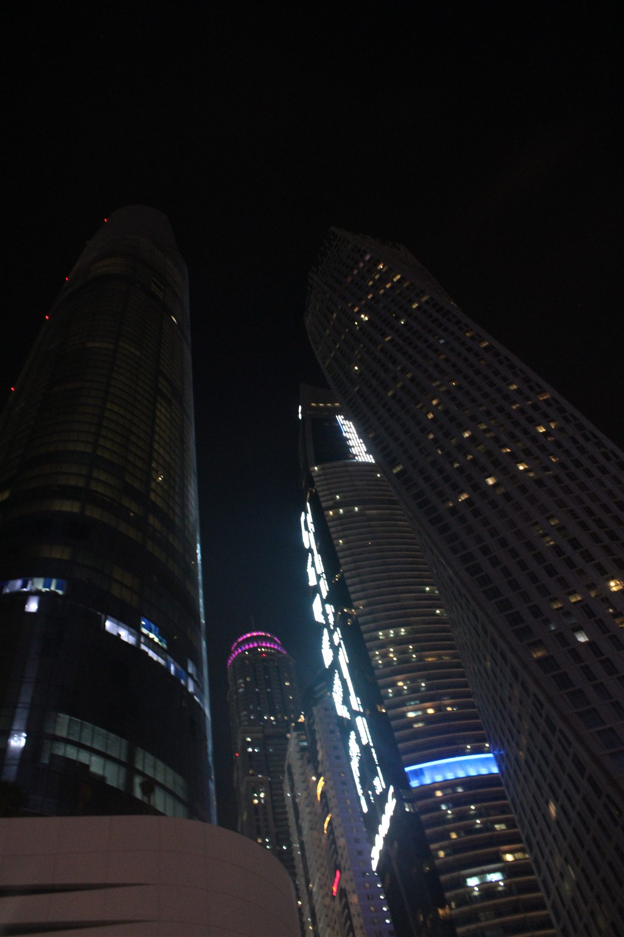 Dubai towers viewed from below at night