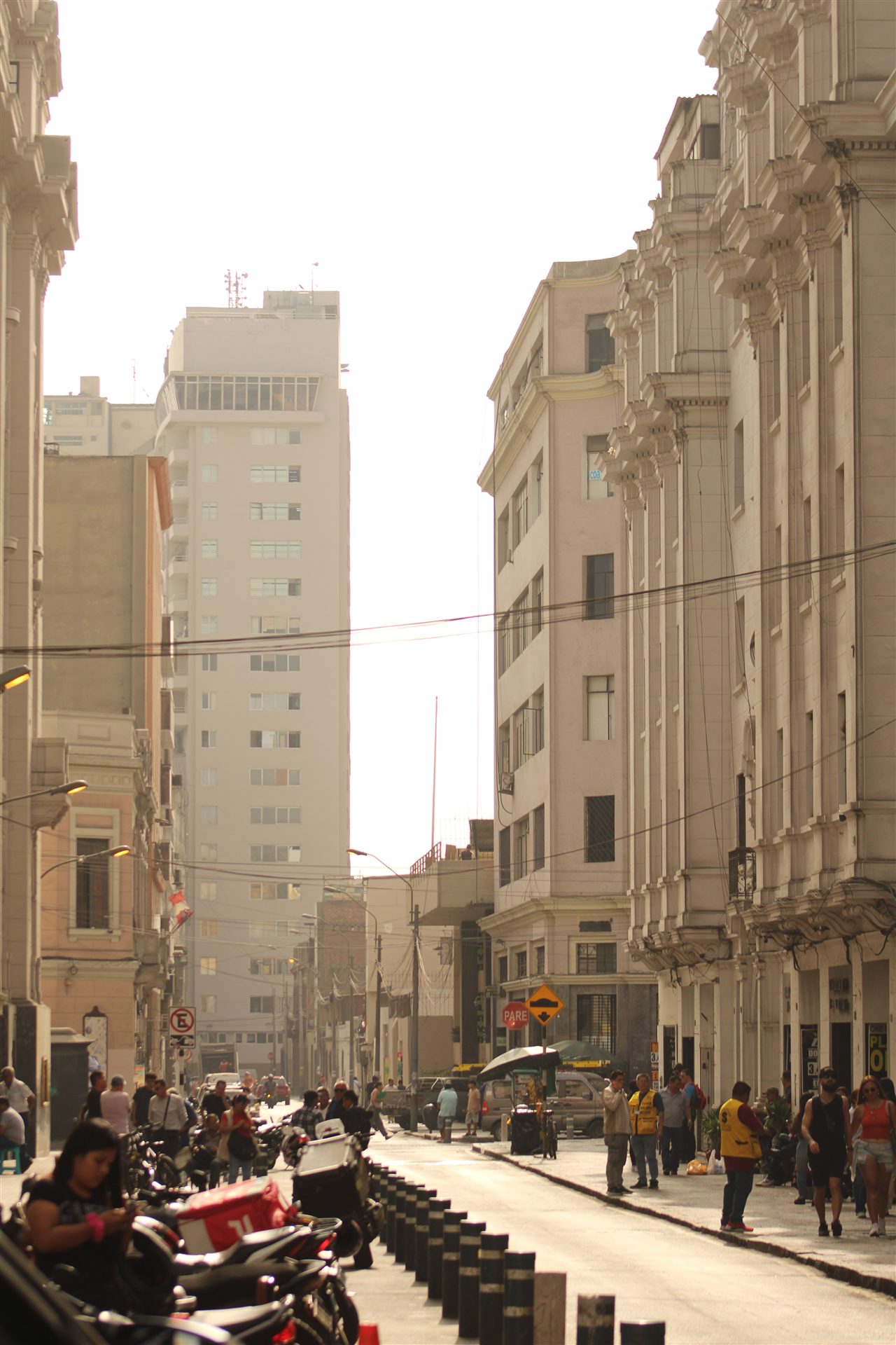 A busy sunlit street in central Lima