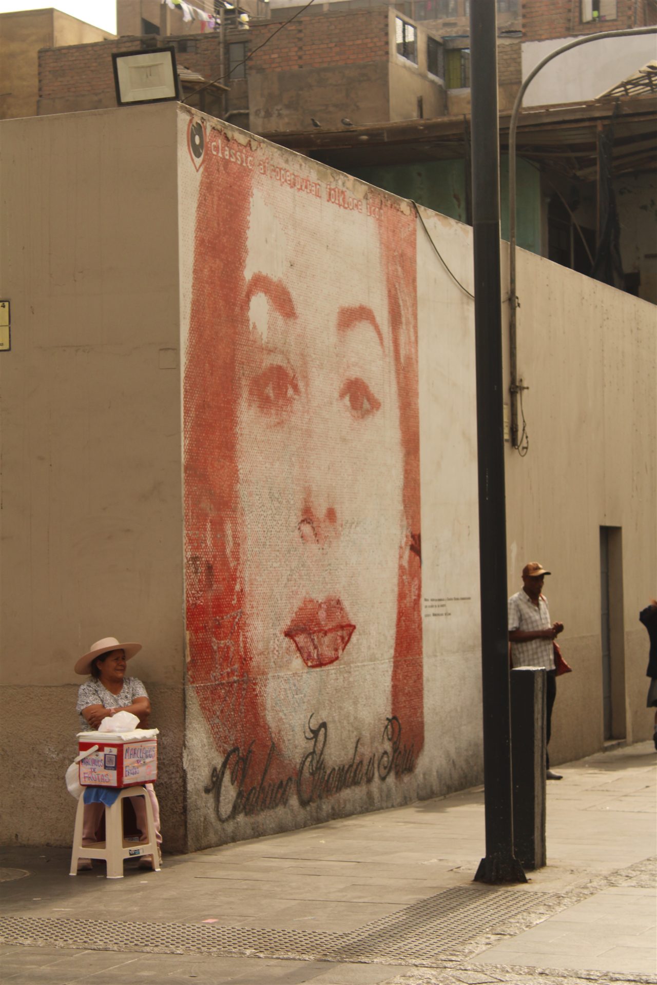 Street mural and local vendors in Lima