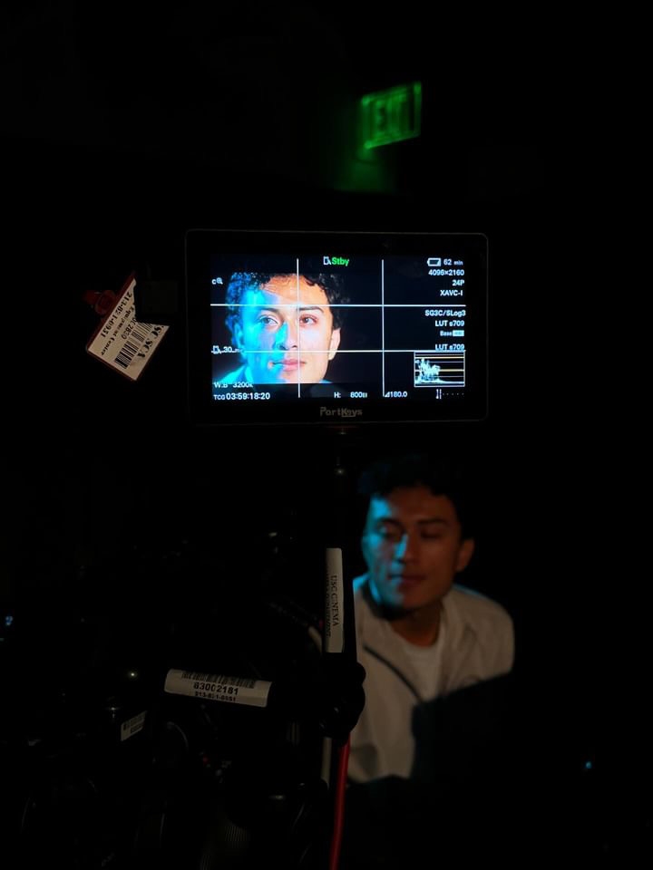 Camera monitor framing Damian during a production
