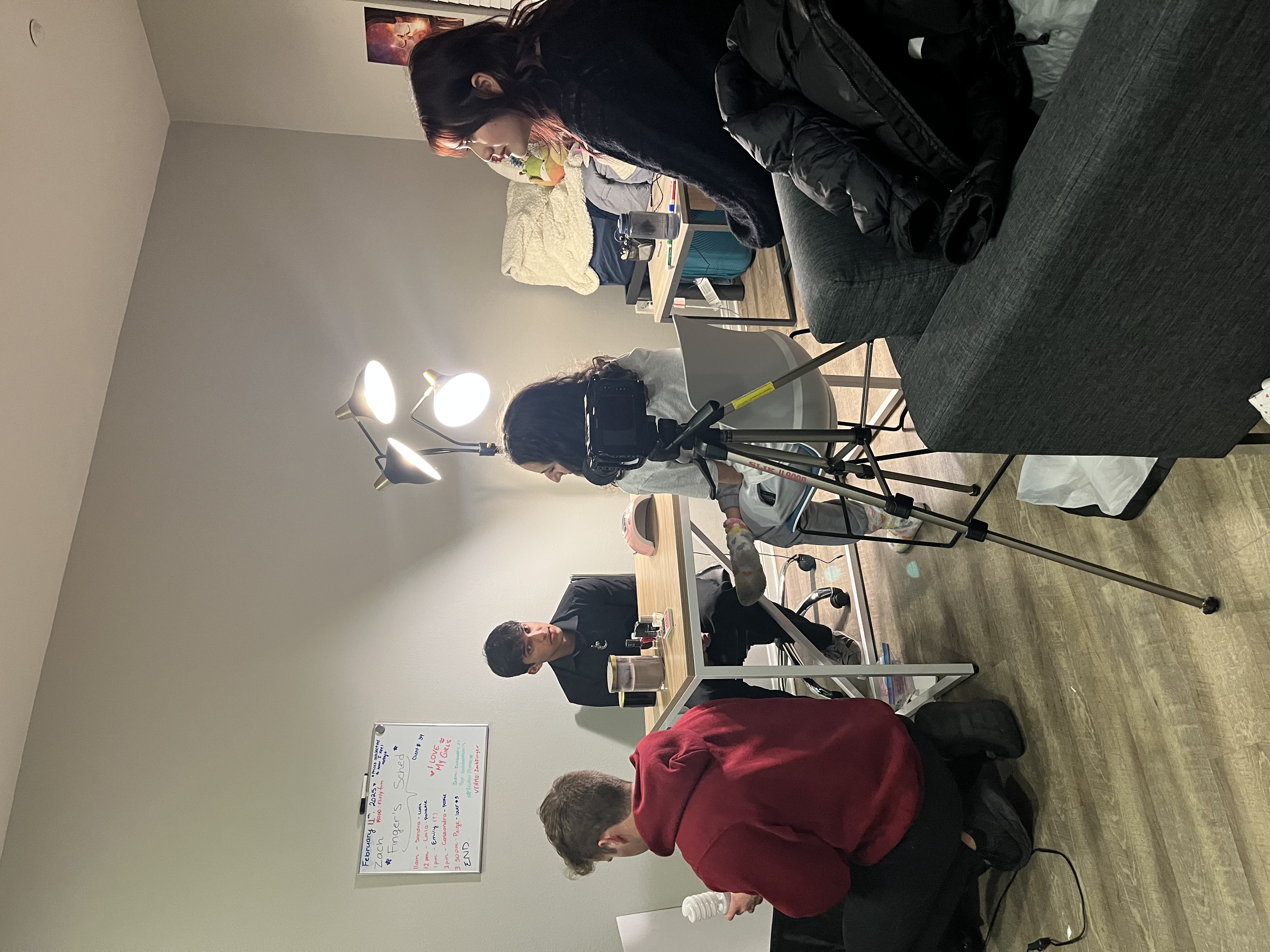 Student film crew preparing a scene in an apartment set